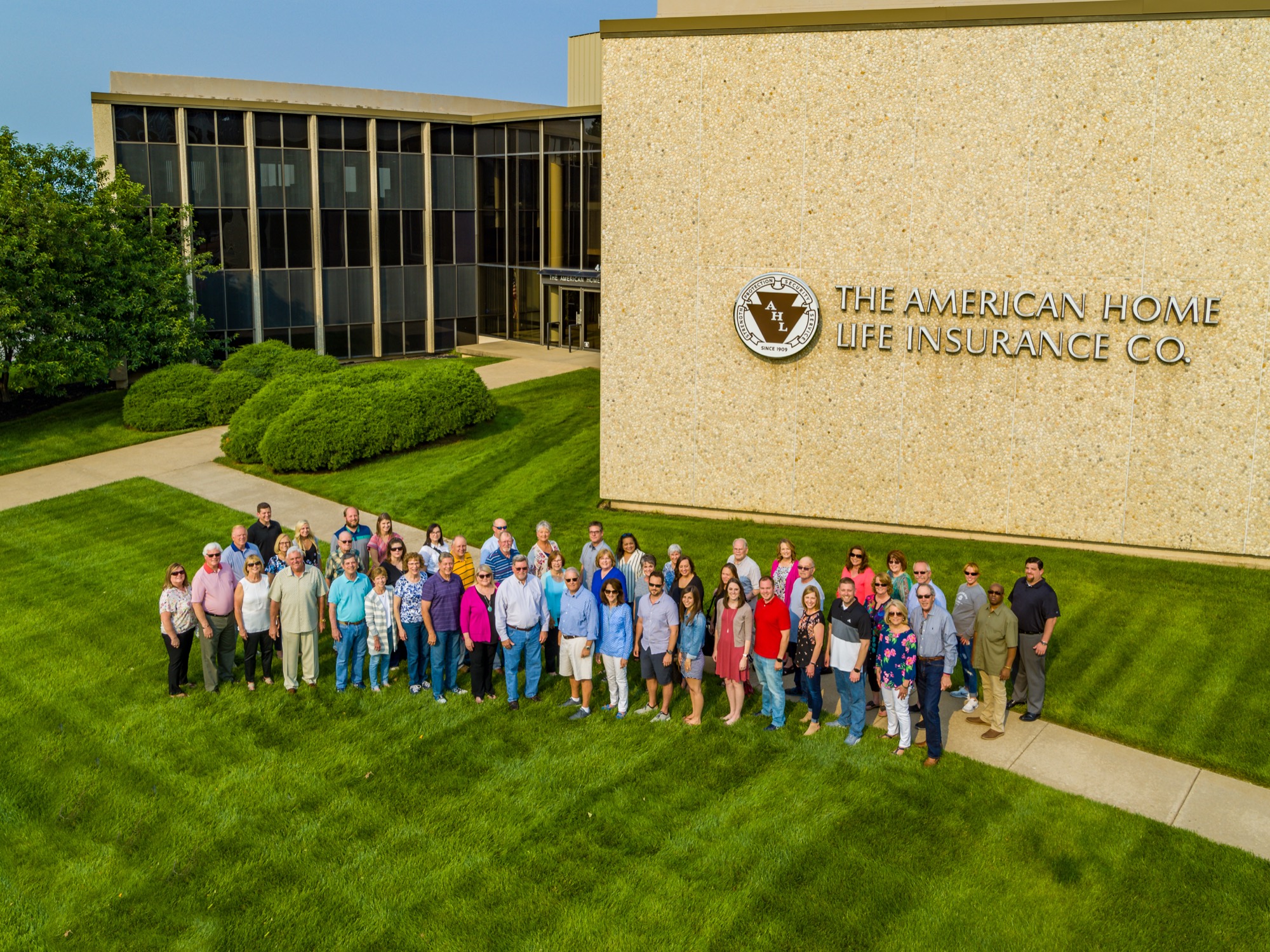 The American Home Life team gathered on the lawn outside the company's Topeka, Kansas headquarters